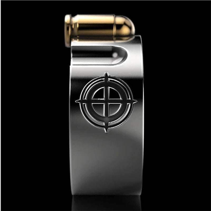 A silver-toned metal money clip shaped like a bullet casing, featuring a black target emblem on the front and a gold-colored bullet tip at the top, set against a solid black background.
