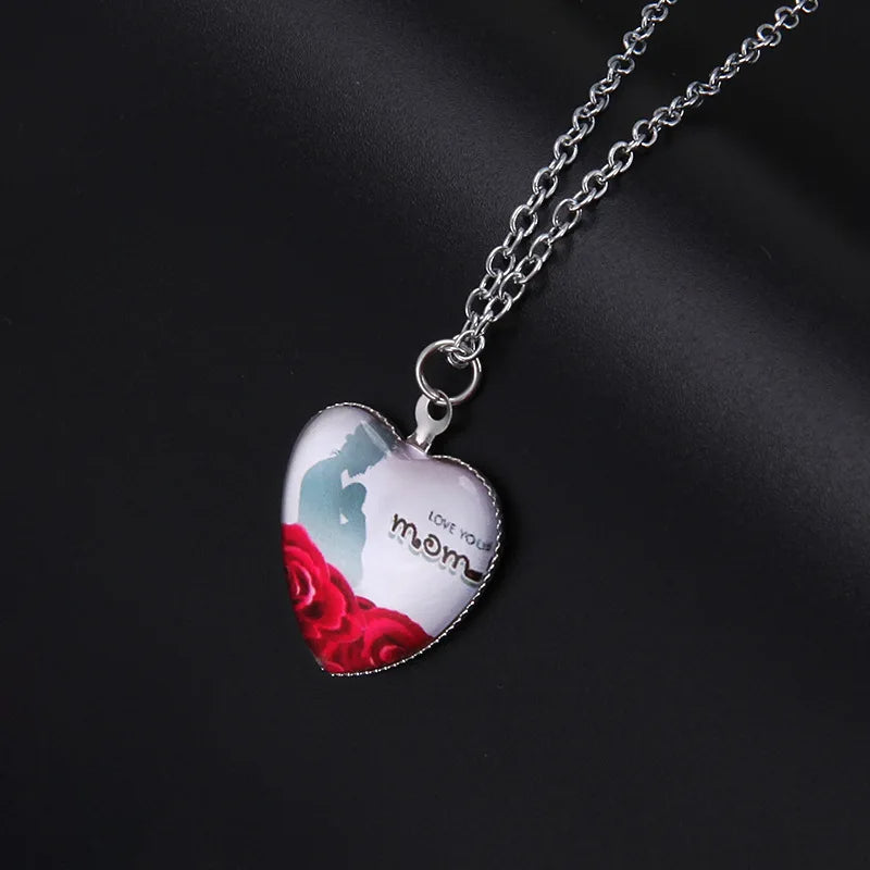 Heart-shaped pendant with red roses and 'love your mom' text on a dark background