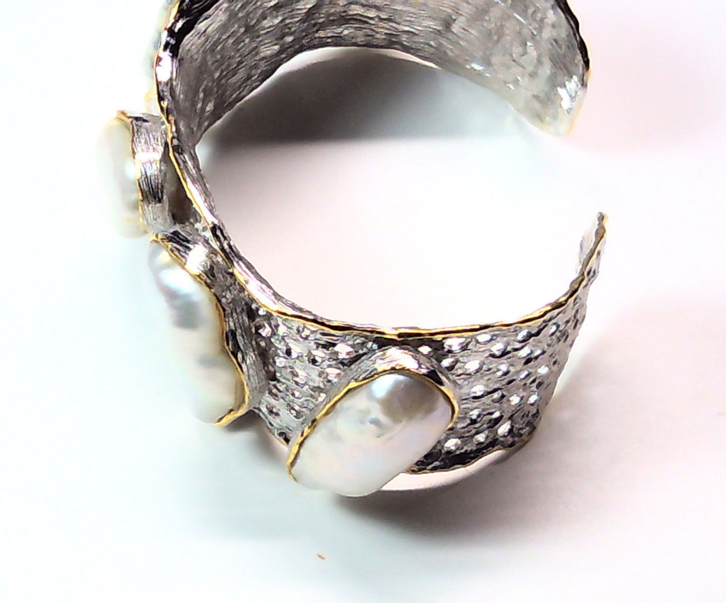 Handmade genuine .925 sterling silver bracelet laced with 14K gold overlay. Has large inlaid baroque pearls AAA grade. Truly a unique item.
