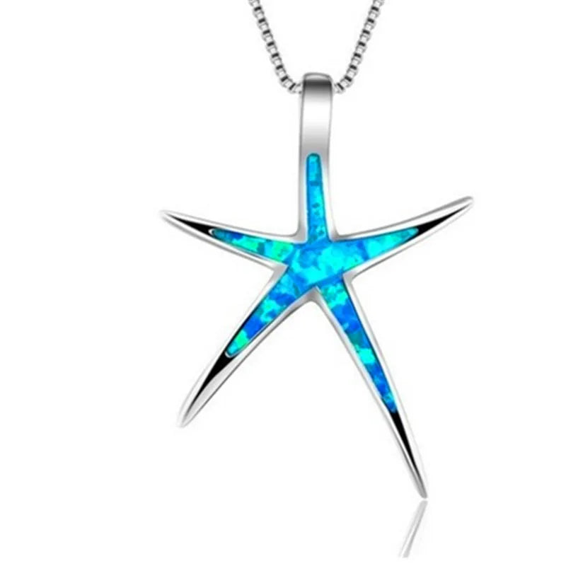 Starfish-shaped pendant with blue opal inlay on a white background