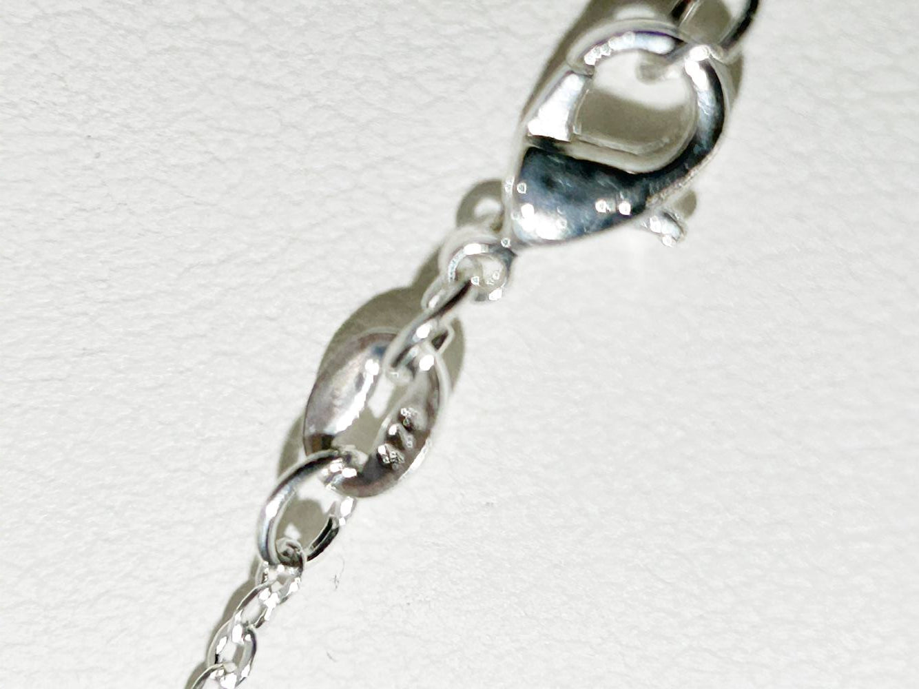 silver chain with quality stamp tag
