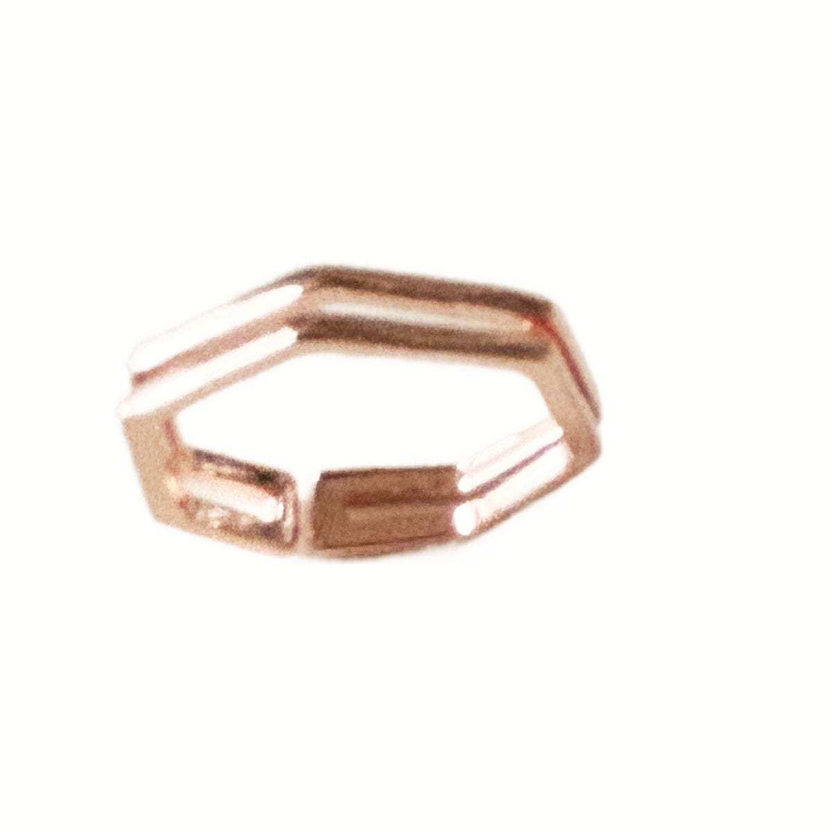 A rose gold hexagonal open ring band, photographed on a plain white background.