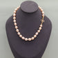 A beautiful 100% handmade, freshwater pearl necklace with golden flower buckle, 10mm, perfect for bridal jewelry, Mother's Day, birthday gifts, parties, giving the perfect ideal gift choice