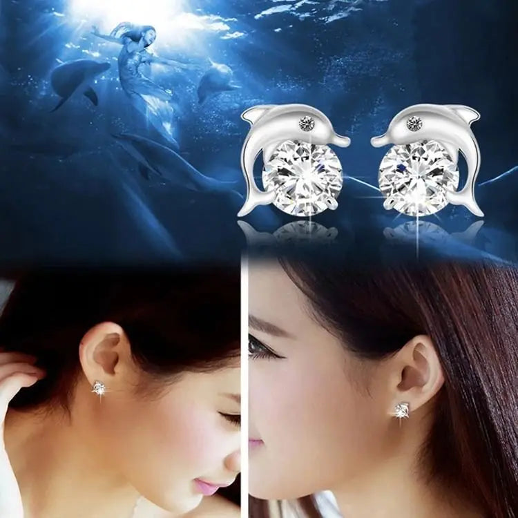 Silver dolphin-shaped stud earrings with round clear gemstones, shown with an underwater mermaid scene and two close-up views of a woman wearing the earrings.