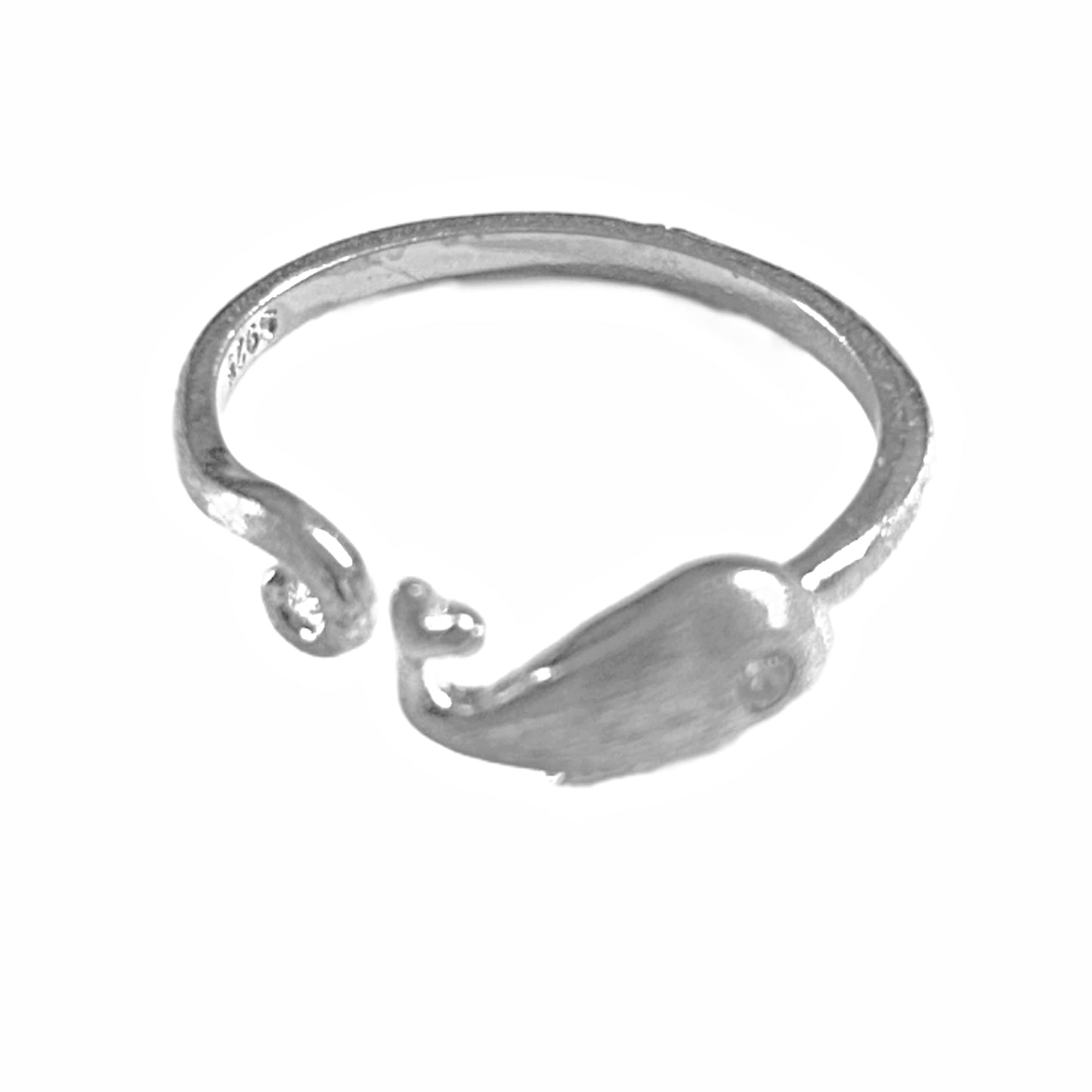A silver-toned open ring band featuring a small whale-shaped charm attached near one end, shown on a plain white background.