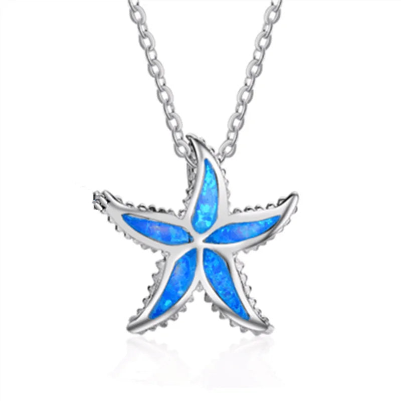 A silver starfish pendant necklace with vibrant blue opal inlay, suspended from a matching silver chain against a white background.