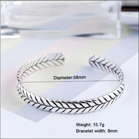 Silver bracelet with measurements on a white background