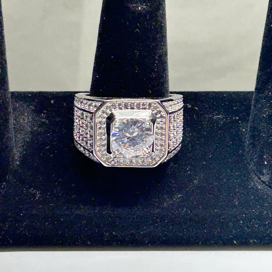 Diamond ring on a black stand with a white background