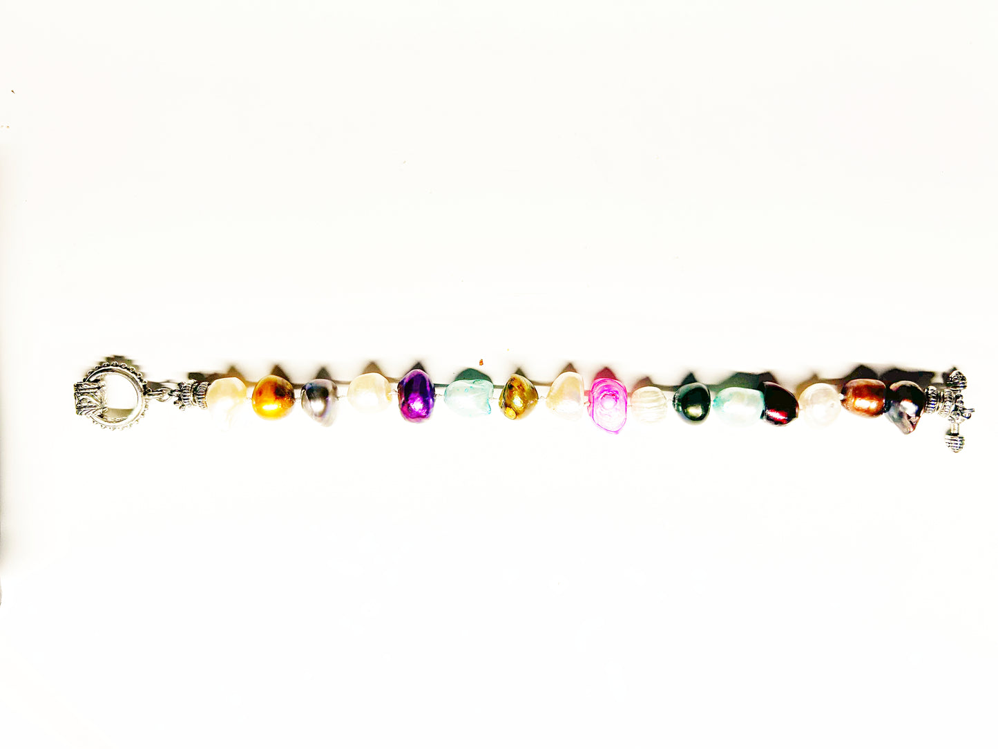 Multicolored beaded bracelet with a crown charm on a white background