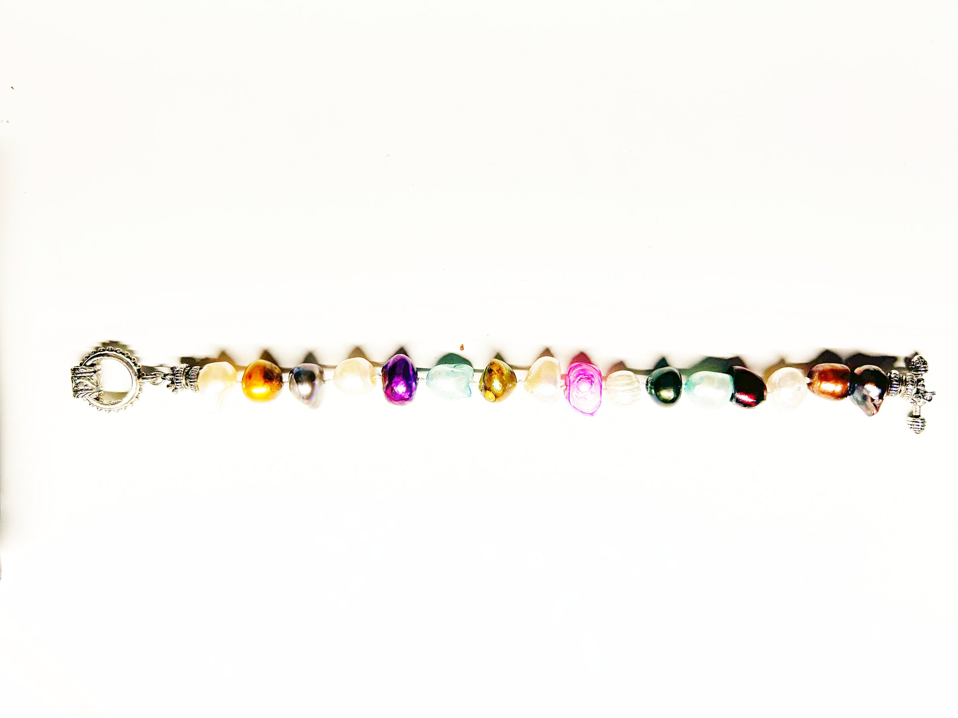 Multicolored beaded bracelet with a crown charm on a white background