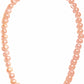 Necklace with pink pearls on a white background