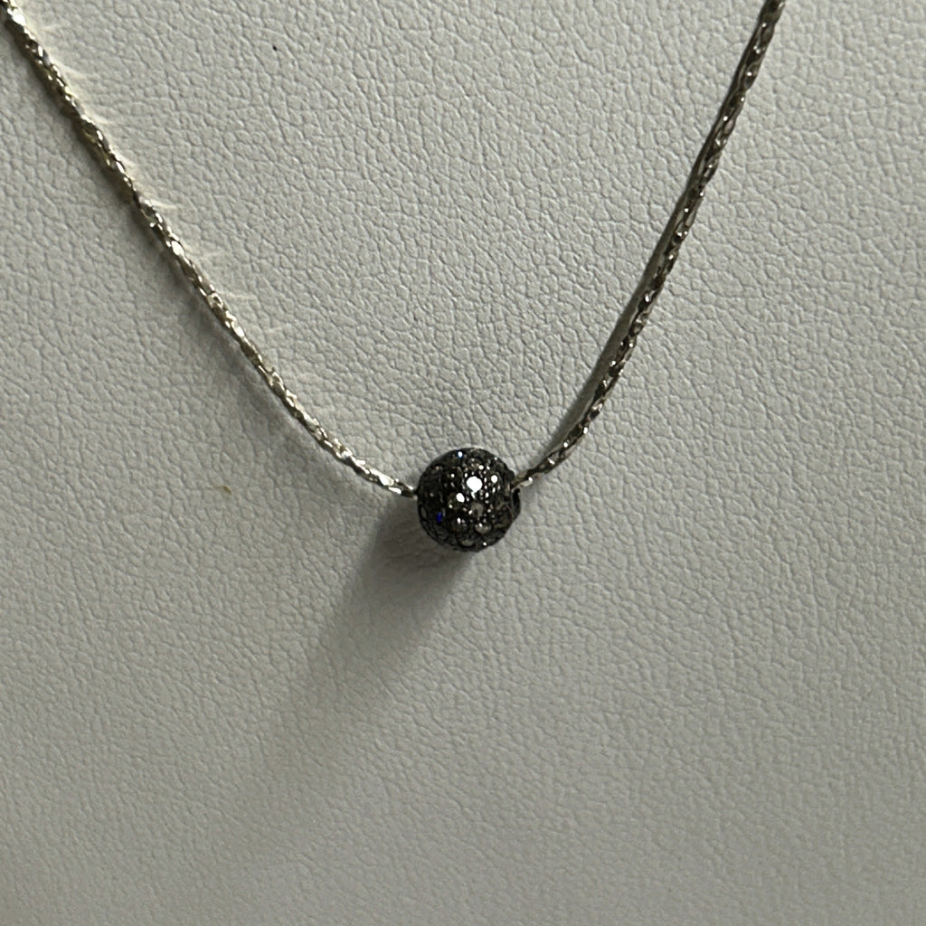 natural light photo of diamond and silver pendant