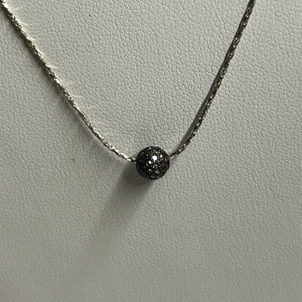 natural light photo of diamond and silver pendant