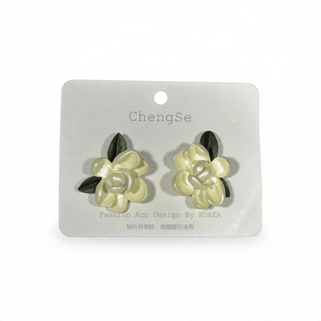 Providence Wholesale Silver floral stud earrings with cream layered petals and dark green leaf accents.