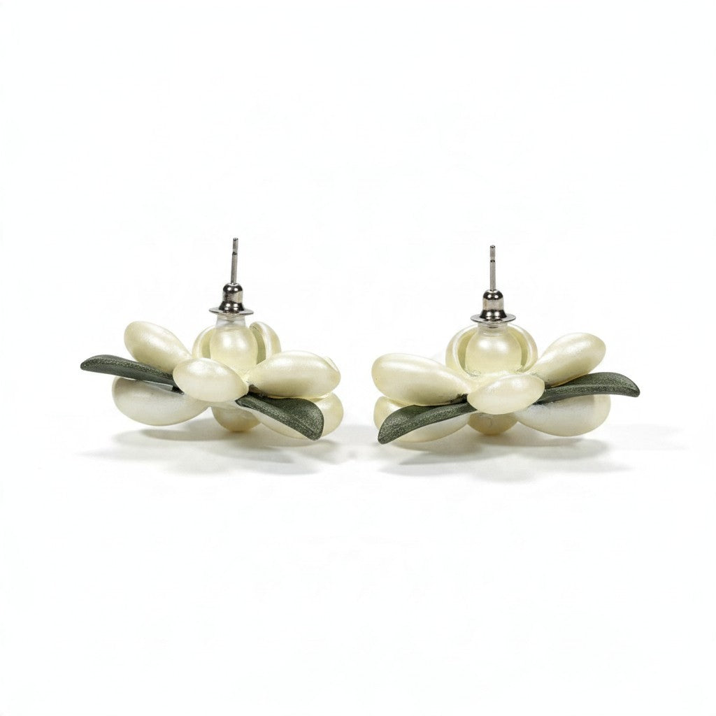 Providence Wholesale Silver floral stud earrings with cream layered petals and green leaf accents on white background.