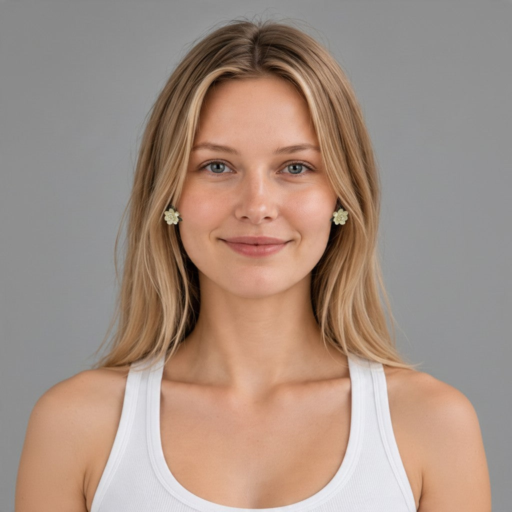 Providence Wholesale Silver floral stud earrings with layered petals and leaf accents worn by a woman.