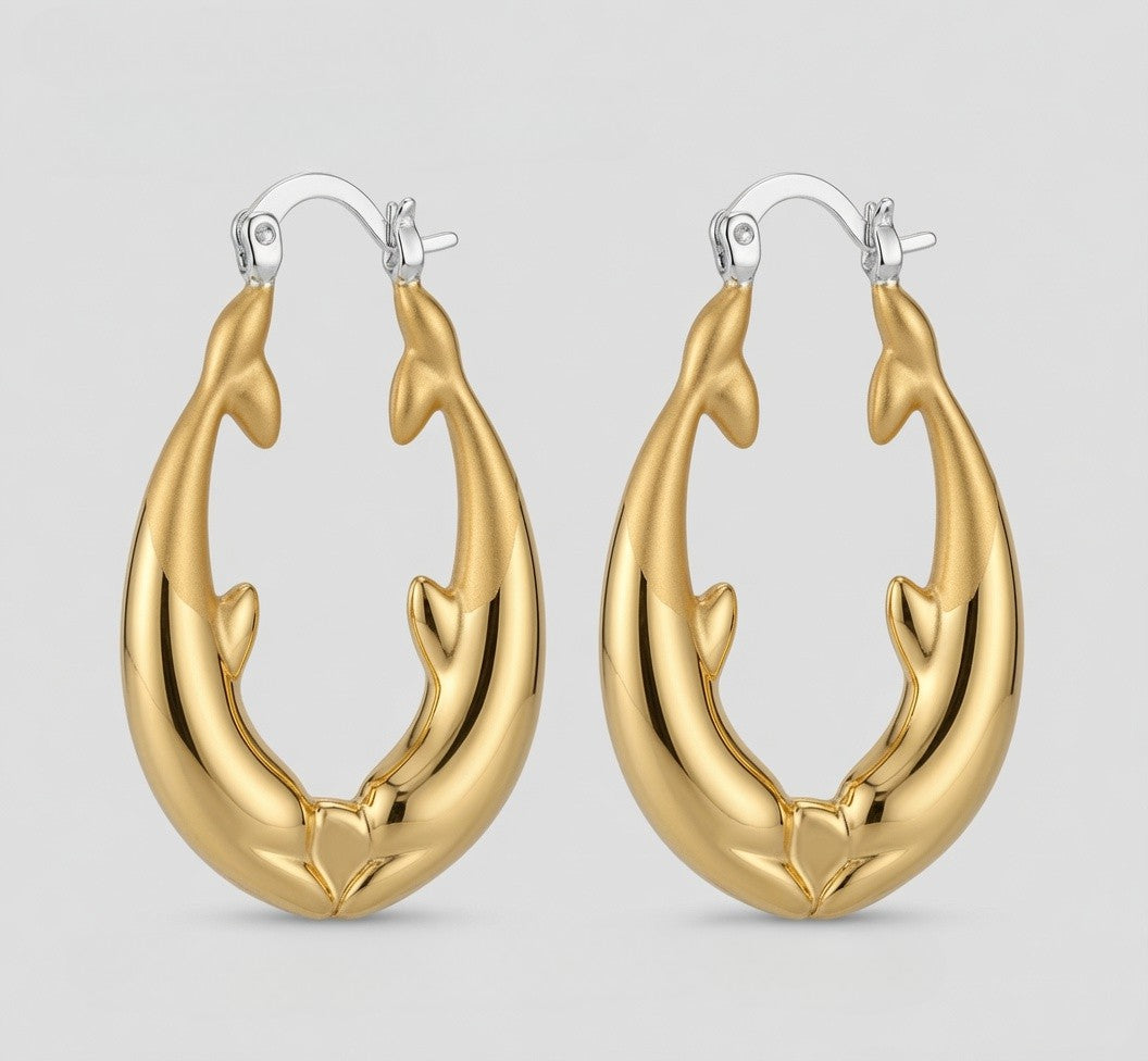 A pair of kissing gold hoop earrings shaped like two intertwined dolphins facing inward, with 925 silver fishhook backs, shown on a light gray background.