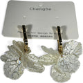 Providence Wholesale Silver floral petal drop hoop earrings with textured translucent white charms on gold hoops.