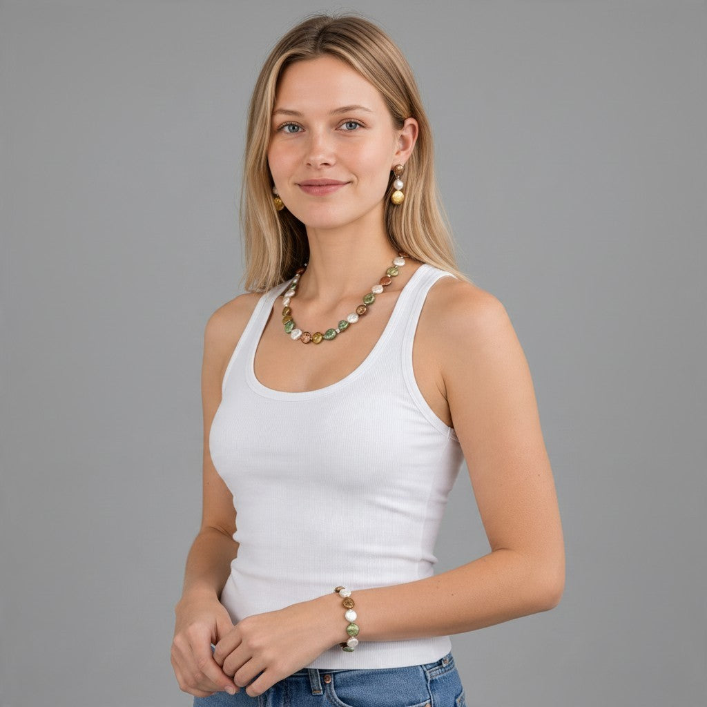 Model wearing a Providence Wholesale Silver three-piece multicolor coin pearl necklace, bracelet, and drop earrings.