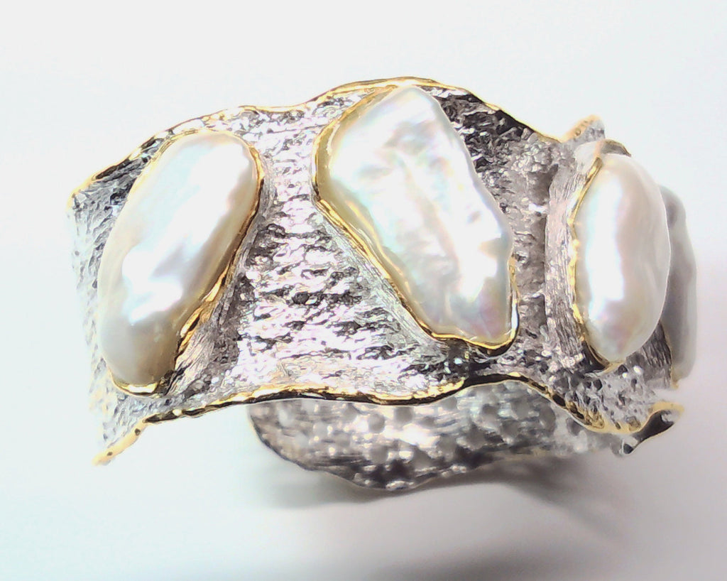 Handmade genuine .925 sterling silver bracelet laced with 14K gold overlay. Has large inlaid baroque pearls AAA grade. Truly a unique item.