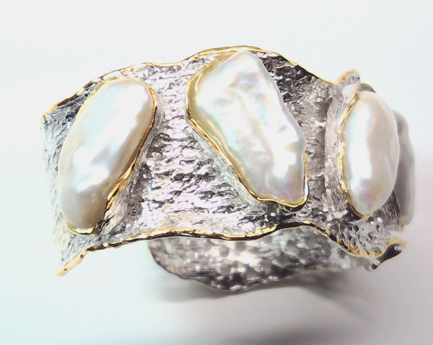 Handmade genuine .925 sterling silver bracelet laced with 14K gold overlay. Has large inlaid baroque pearls AAA grade. Truly a unique item.