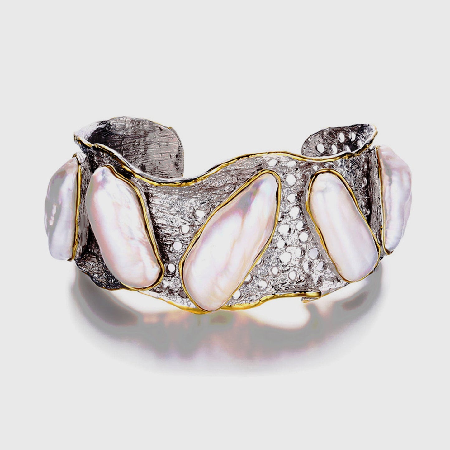 Handmade genuine .925 sterling silver bracelet laced with 14K gold overlay. Has large inlaid baroque pearls AAA grade. Truly a unique item.