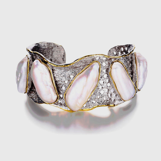 Handmade genuine .925 sterling silver bracelet laced with 14K gold overlay. Has large inlaid baroque pearls AAA grade. Truly a unique item.