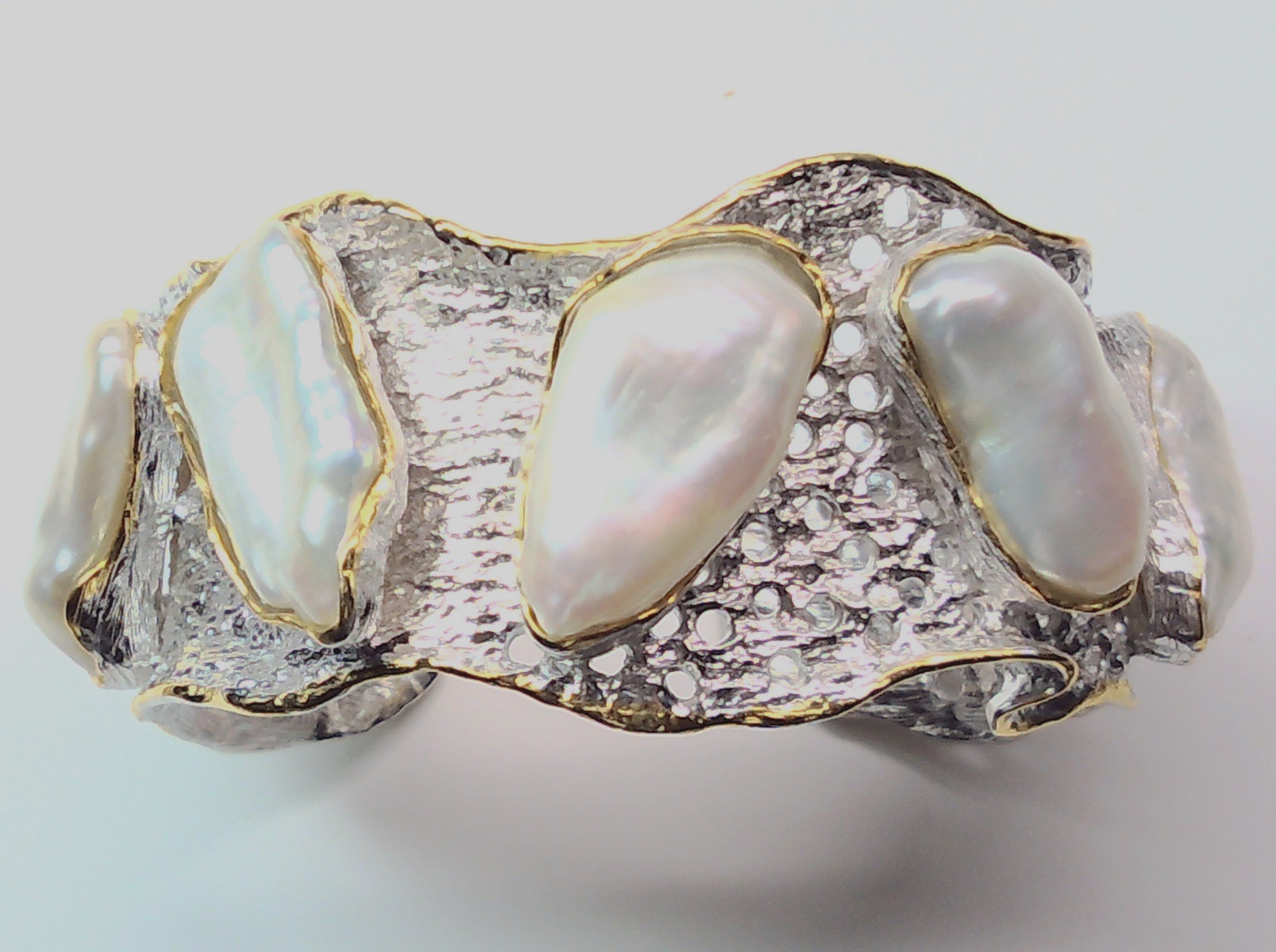 Handmade genuine .925 sterling silver bracelet laced with 14K gold overlay. Has large inlaid baroque pearls AAA grade. Truly a unique item.