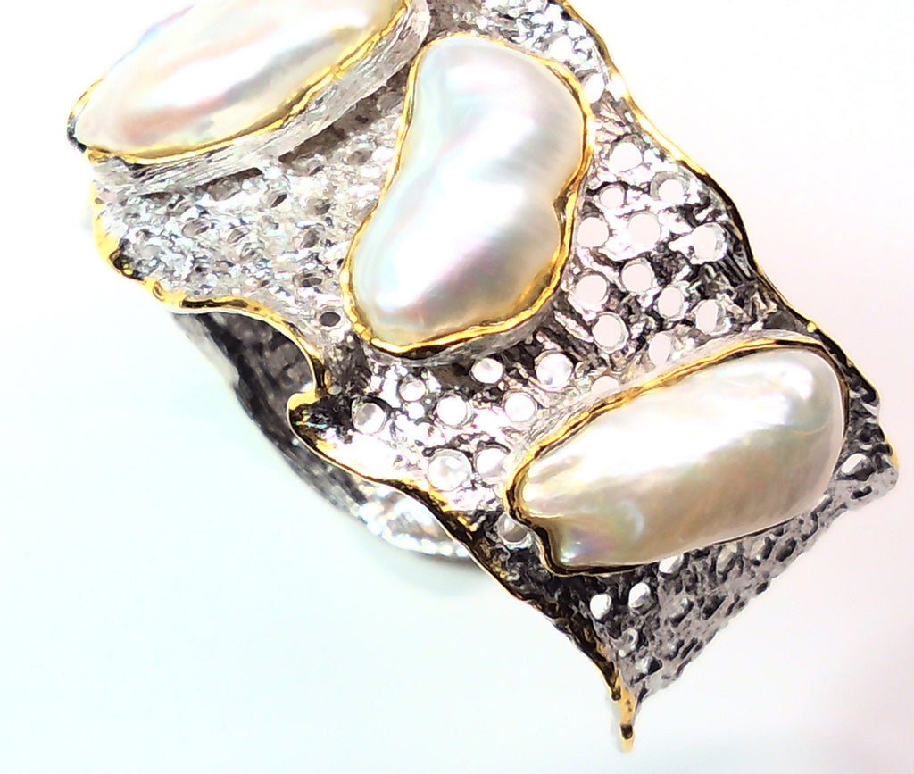 Handmade genuine .925 sterling silver bracelet laced with 14K gold overlay. Has large inlaid baroque pearls AAA grade. Truly a unique item.