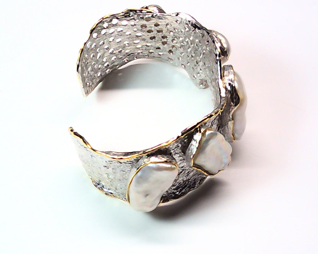 Handmade genuine .925 sterling silver bracelet laced with 14K gold overlay. Has large inlaid baroque pearls AAA grade. Truly a unique item.