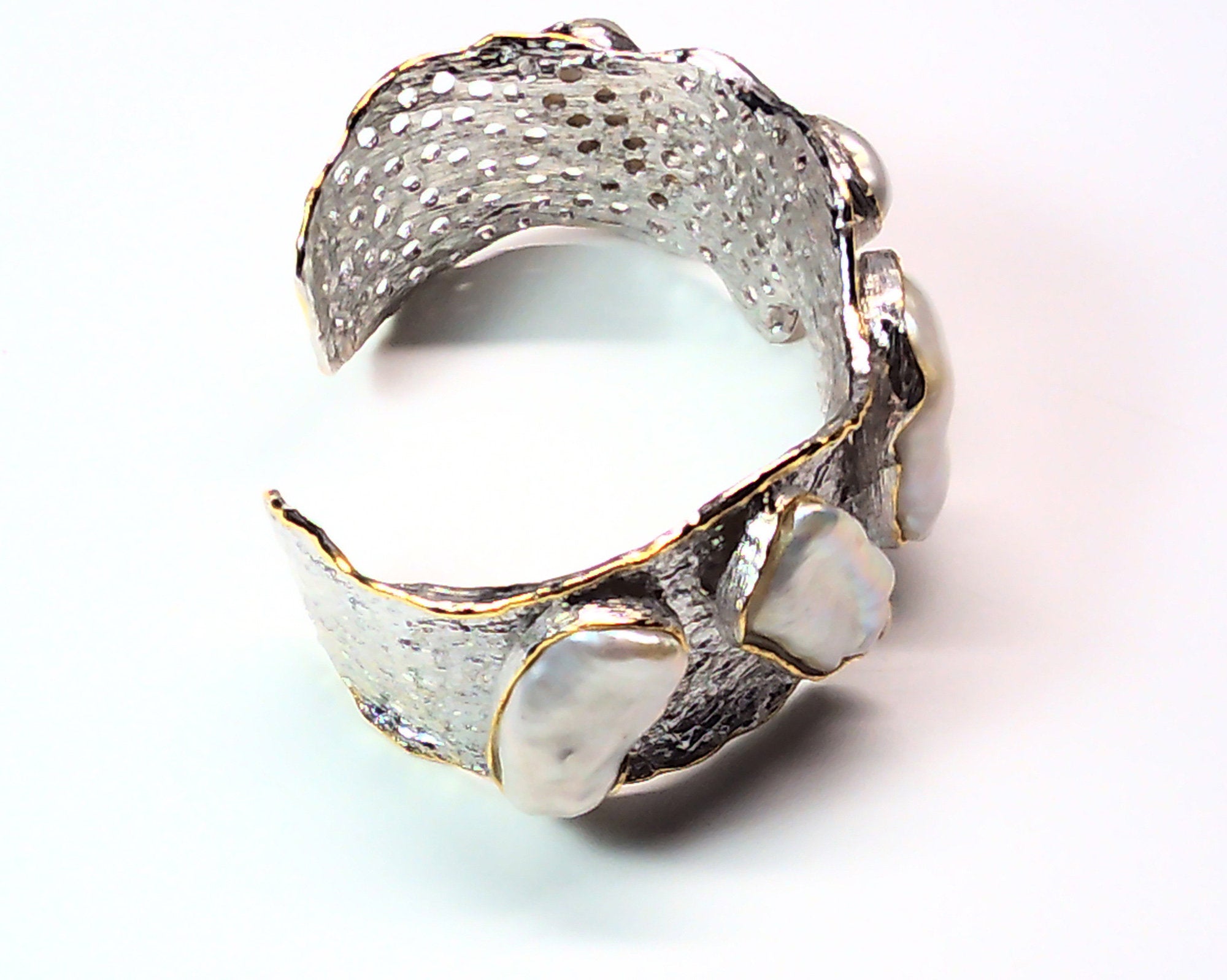 Handmade genuine .925 sterling silver bracelet laced with 14K gold overlay. Has large inlaid baroque pearls AAA grade. Truly a unique item.