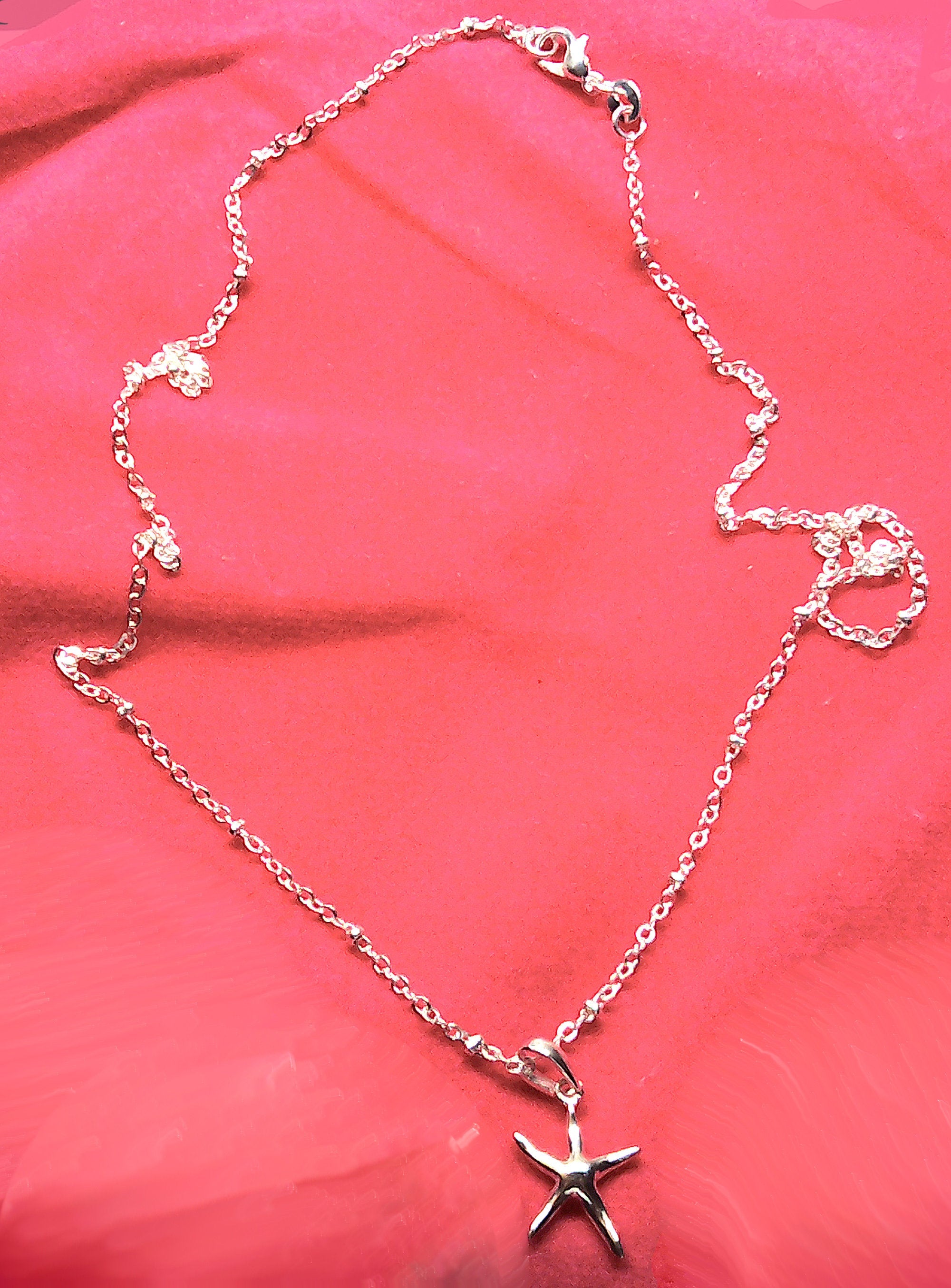 Sterling silver starfish pendant with a fancy cable and ball chain.