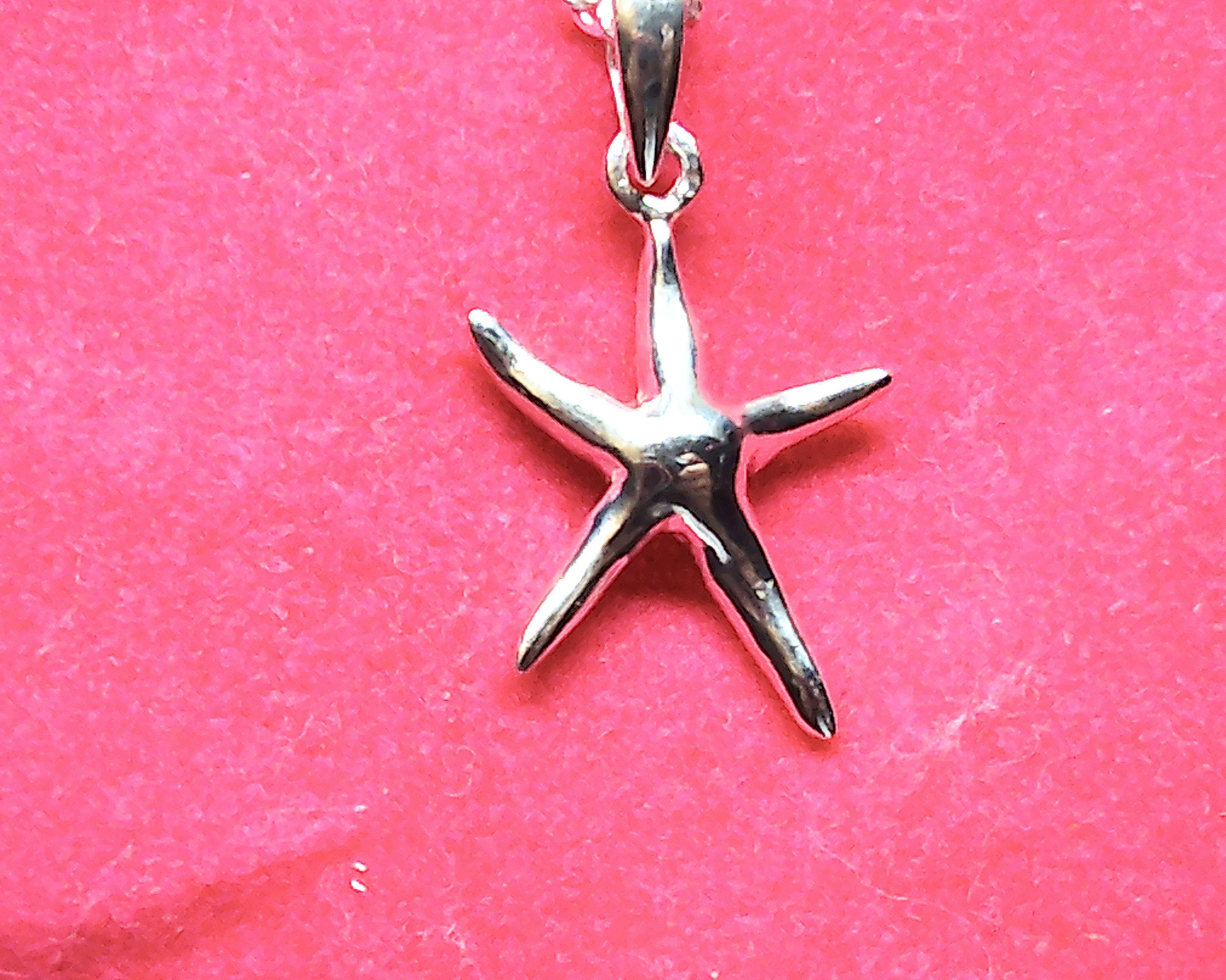 Sterling silver starfish pendant with a fancy cable and ball chain.